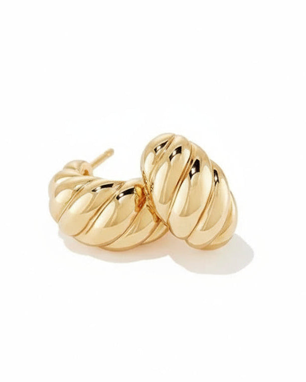 Pair of gold croissant hoop earrings on a white background