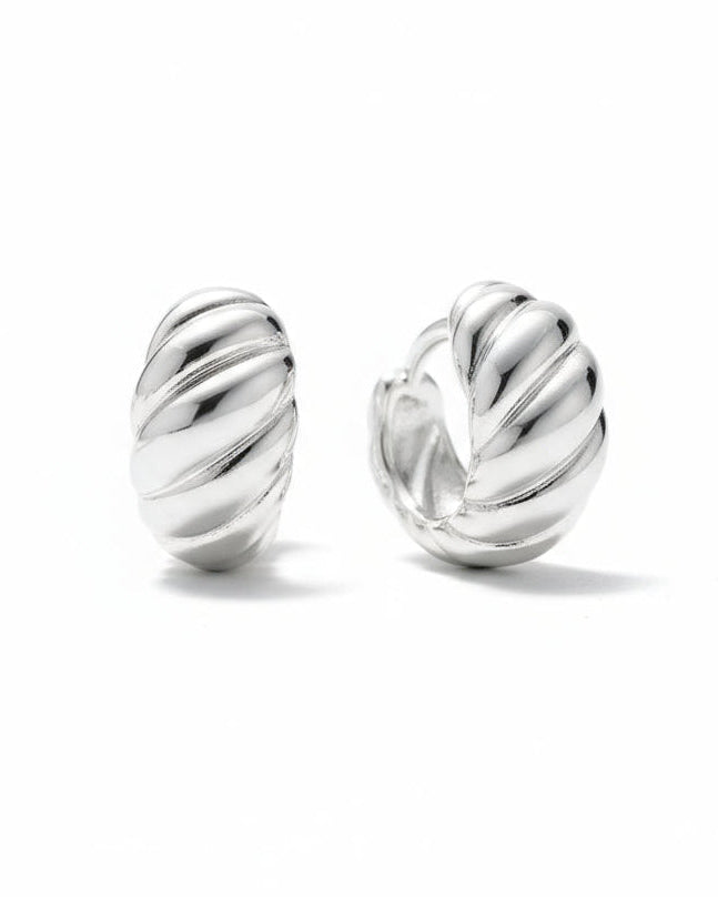 Pair of silver hoop croissant earrings on a white background